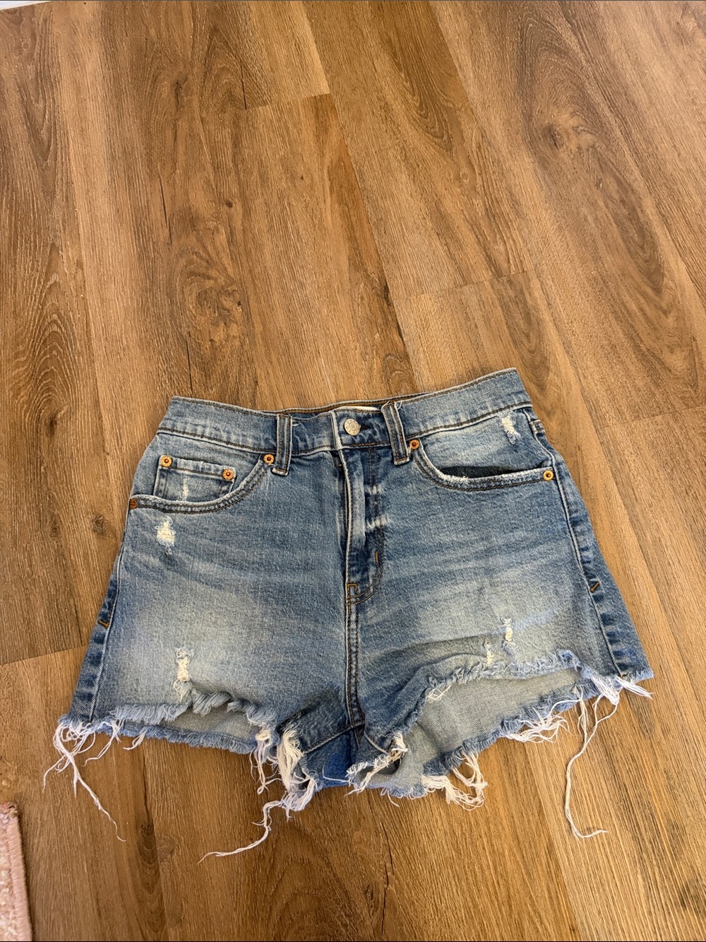 Distressed High-Rise Denim Shorts in Faded Blue